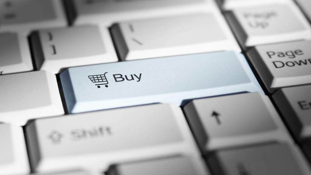 Close-up of a keyboard with a prominent 'buy' button.