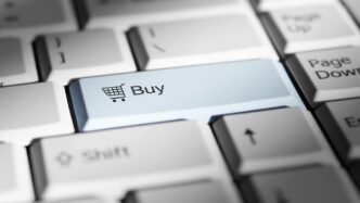 Close-up of a keyboard with a prominent 'buy' button.