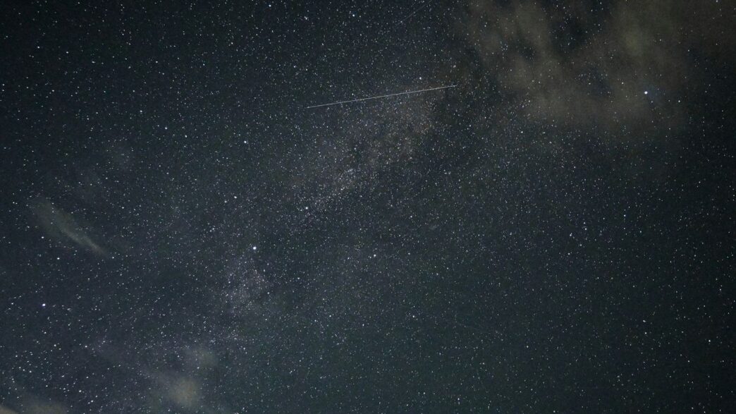 A plane flying through the night sky