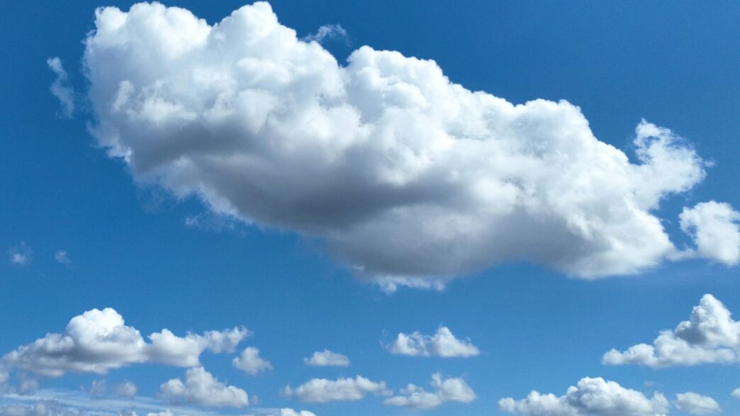 Fluffy white clouds in a clear blue sky