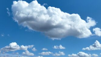 Fluffy white clouds in a clear blue sky