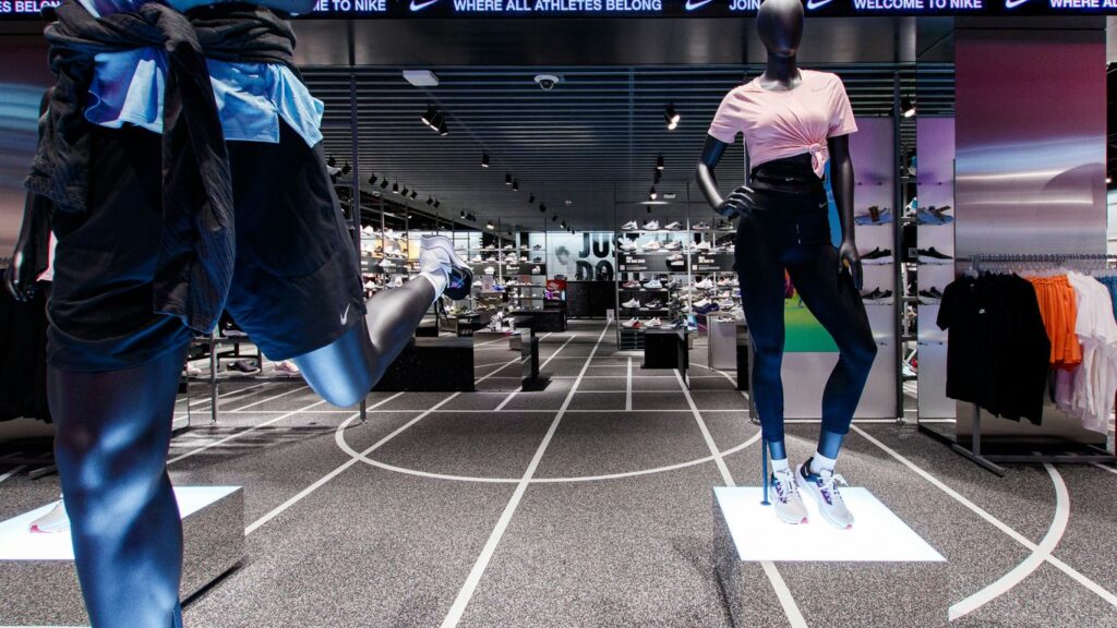 two mannequins dressed in sports clothing in a store