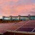 solar panels on brown field under white clouds during daytime