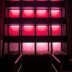 Modern building facade illuminated with bright pink lights