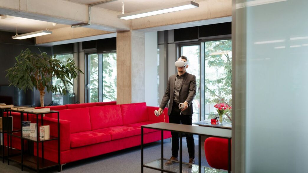 a man standing in a room with a red couch