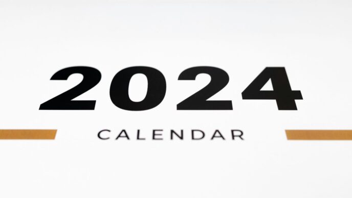 a white wall with a black and orange calendar on it