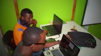 two men using laptop computes