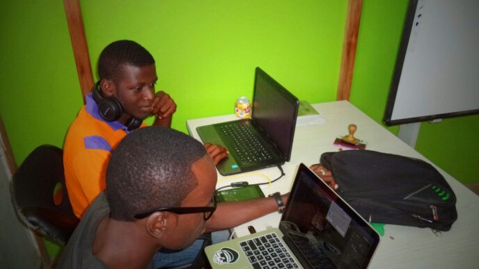 two men using laptop computes
