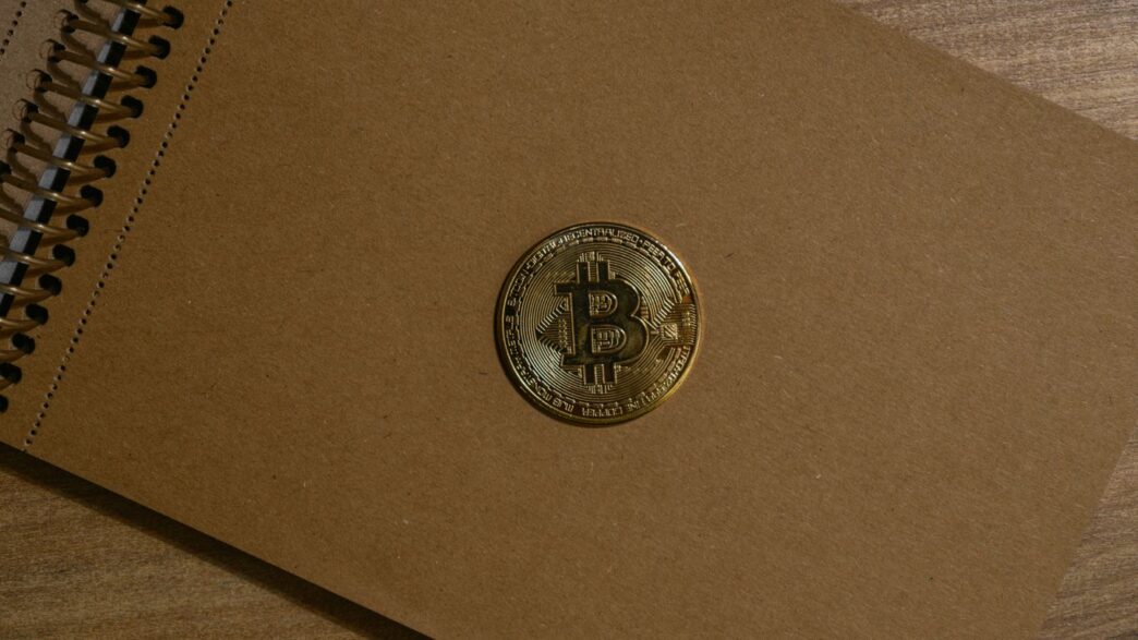 a brown notebook with a bitcoin on it