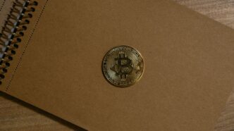 a brown notebook with a bitcoin on it