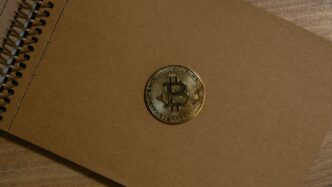a brown notebook with a bitcoin on it
