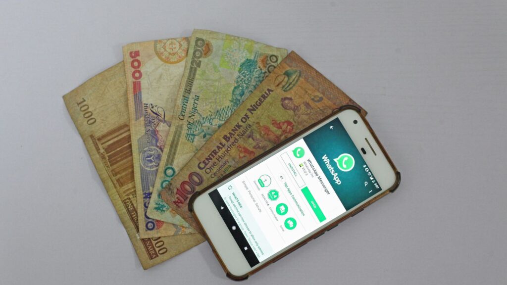 white Android smartphone beside banknotes