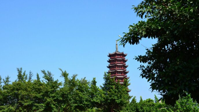 a tall tower with a statue on top of it