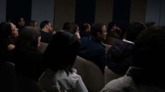 a group of people sitting in a dark room