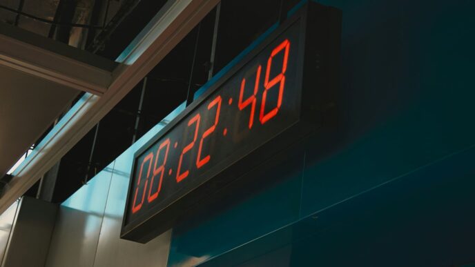 a large red clock mounted to the side of a building