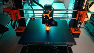 A 3D printer is creating a small object.