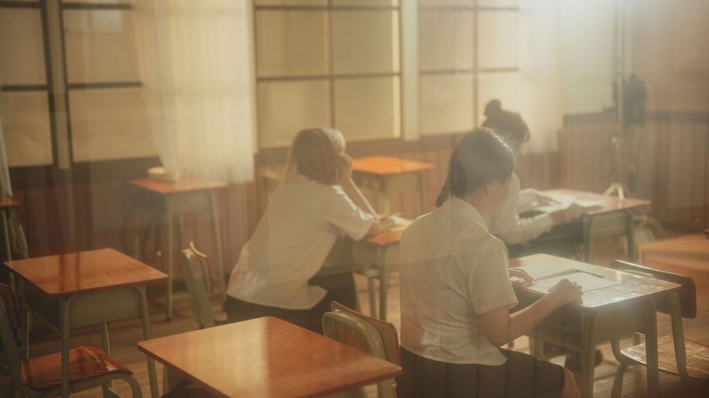 A group of people sitting at desks in a room