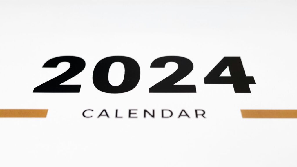 a white wall with a black and orange calendar on it