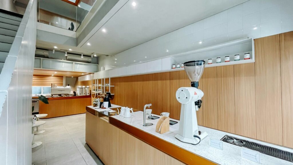 A kitchen with a counter, sink, and stairs