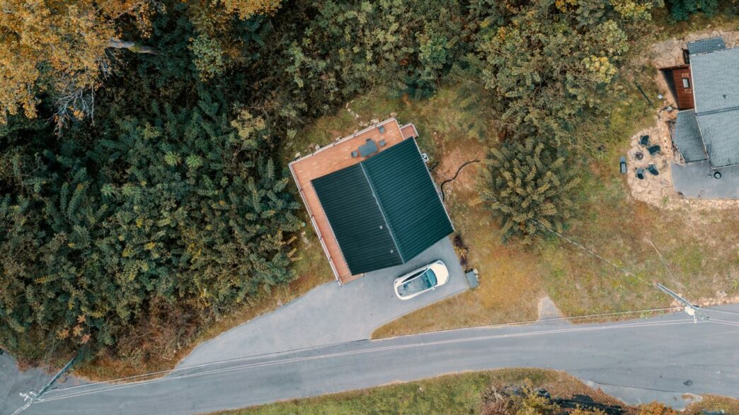 Aerial view of a small cabin surrounded by trees
