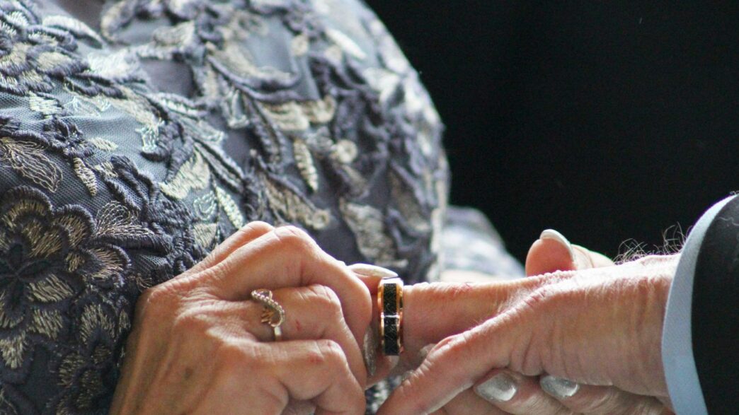 A close up of two people holding hands