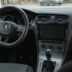 the interior of a car with a steering wheel and dashboard