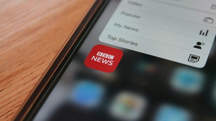 black iphone 5 on brown wooden table
