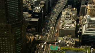 Busy highway traffic amidst tall city buildings
