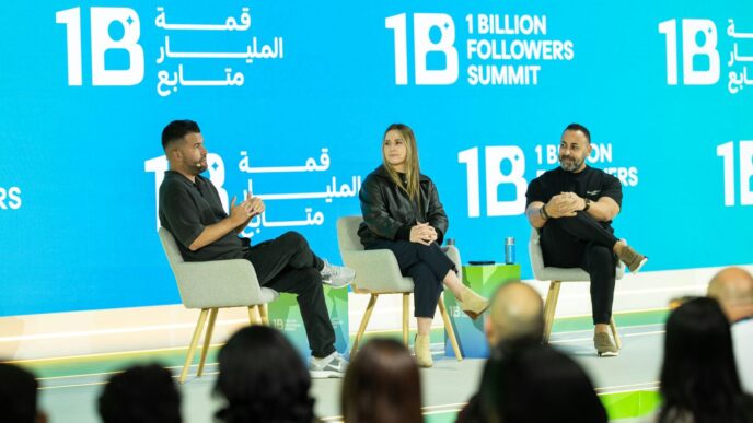 Three people on stage at a summit
