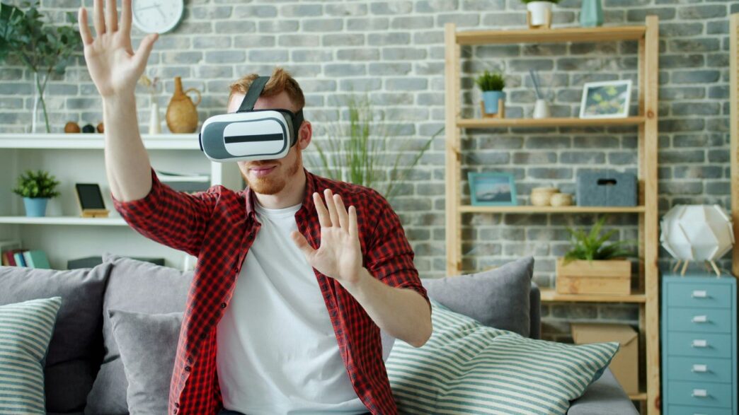 Man wearing virtual reality headset at home