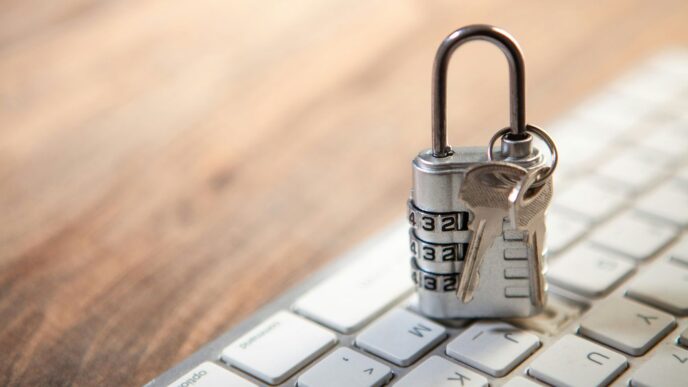 Padlock and keys resting on a computer keyboard.