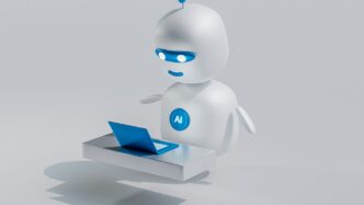 a white robot with blue eyes and a laptop