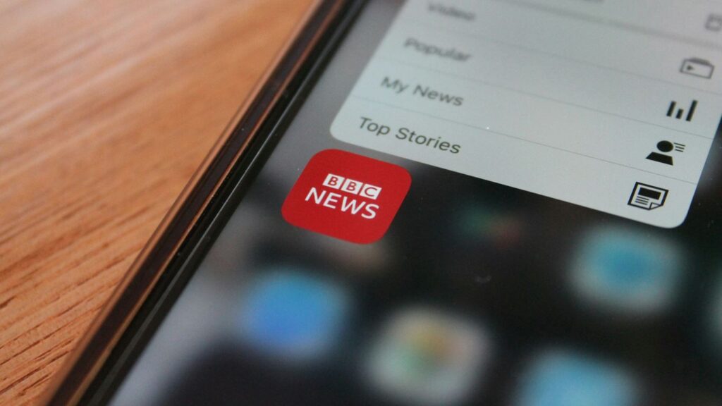black iphone 5 on brown wooden table