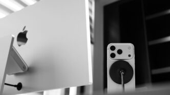 Apple computer monitor with iPhone and charger