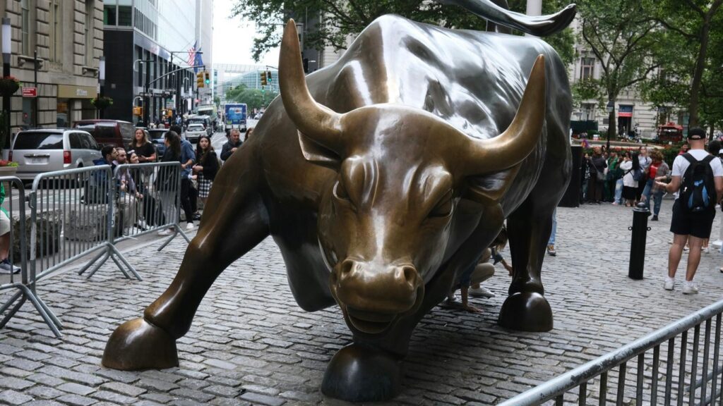 a statue of a bull on a brick street