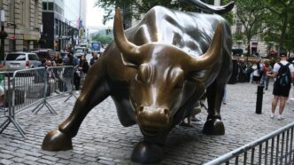 a statue of a bull on a brick street