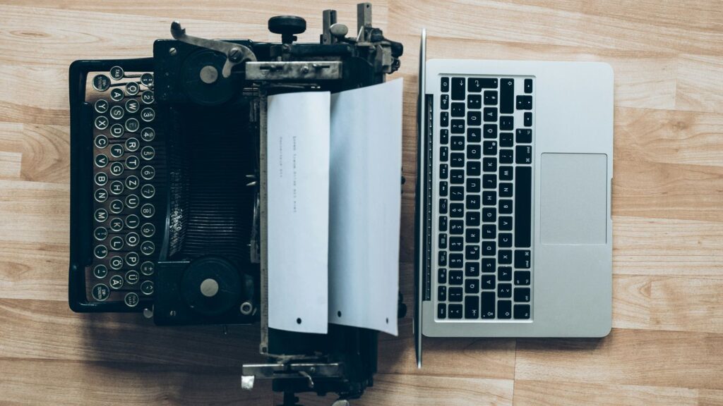 gray typewriter and MacBook