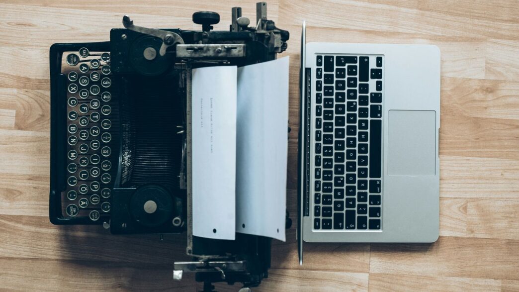gray typewriter and MacBook