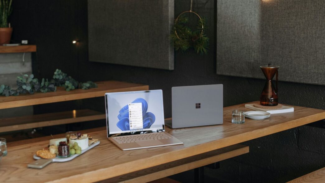Two Microsoft laptops on a table in an office during the holidays