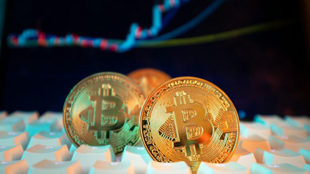 Bitcoin coins are displayed with a stock chart.