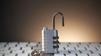 Open padlock with combination lock on keyboard