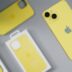 Yellow iPhone with protective cases and packaging