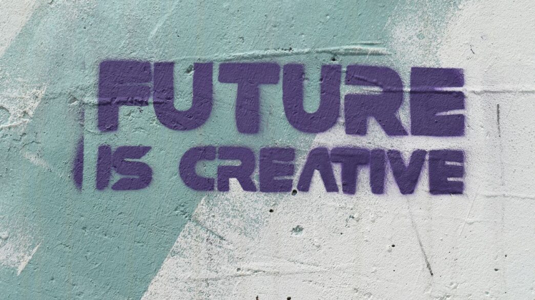 a graffiti on a wall that says, future is creative