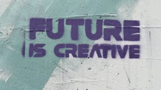 a graffiti on a wall that says, future is creative