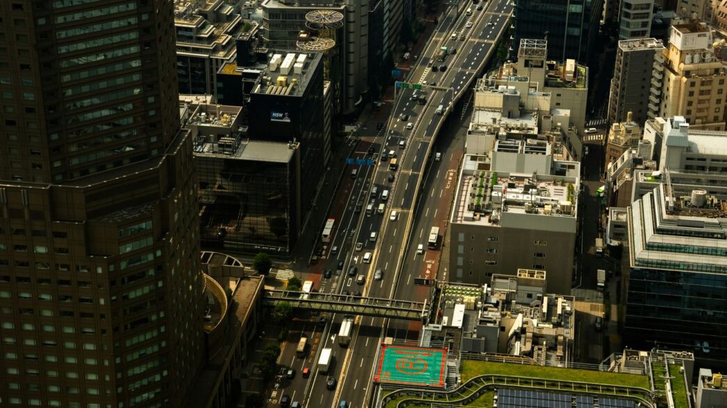 Busy highway traffic amidst tall city buildings
