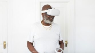 a man wearing a white robe and holding a cup