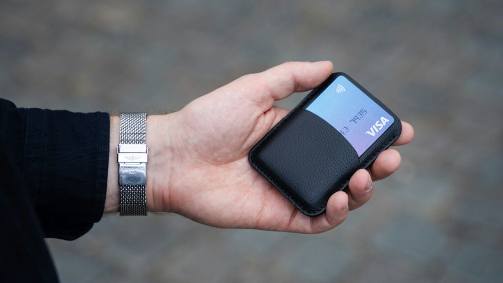 a person holding a cell phone in their hand