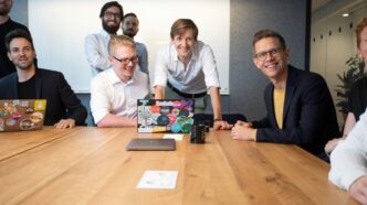 a group of people sitting around a wooden table