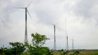 a group of wind turbines on a cloudy day