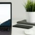 MacBook Pro near green potted plant on table